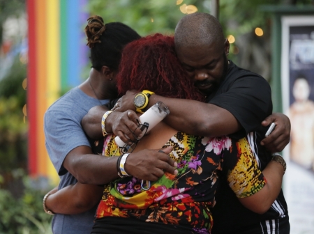 People embrace following a candlelight vigil at the Parliament House Resort after an early morning shooting attack at a gay nightclub in Orlando, Florida, U.S. June 12, 2016.