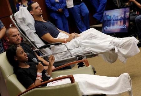 Gunshot survivor Patience Carter (front) recounts her story as fellow survivor Angel Santiago and Dr. Brian Vickaryous look on during a news conference at Florida Hospital Orlando on the shooting at the Pulse gay nightclub in Orlando, Florida, June 14, 2016.