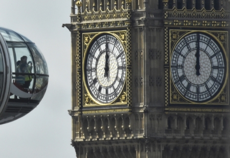 Passengers look out from a pod of the London Eye wheel with Big Ben and the Houses of Parliament seen behind in London, Britain, May 26, 2016.