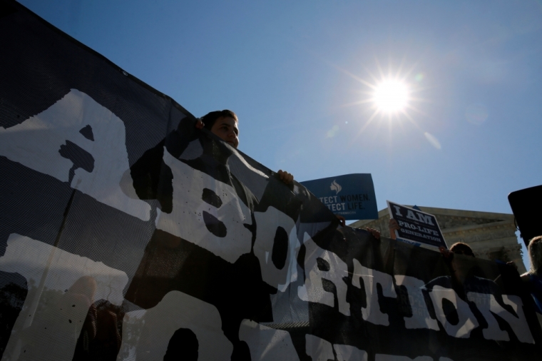 Anti-abortion protesters demonstrate in the hopes of a ruling in their favor on decisions at the Supreme Court building in Washington, U.S. June 20, 2016.