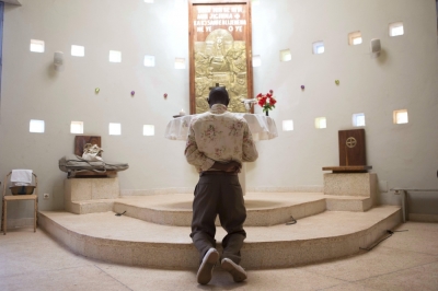 A man prays after mass at the Martyrs of Uganda church in Bamako, Mali, Nov. 8, 2015.