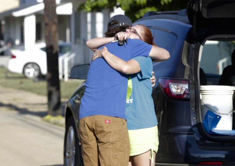 Ami Palmer, 40, hugs her nephew Landon Palmer (L), upon returning to her home after flooding damaged her home in Clendenin, West Virginia, U.S., June 26, 2016.