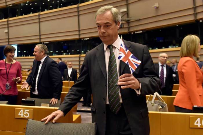 Nigel Farage, the leader of the United Kingdom Independence Party, holds the British flag as he attends a plenary session at the European Parliament on the outcome of the 'Brexit' in Brussels, Belgium, June 28, 2016.