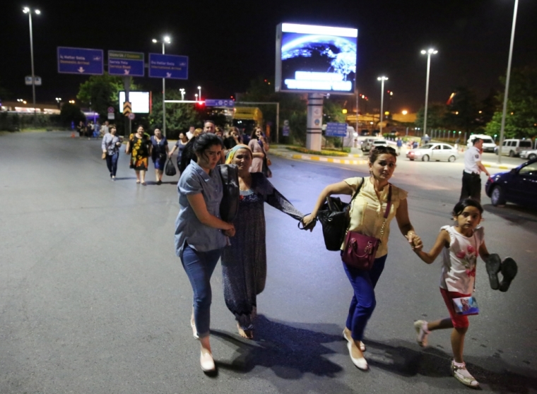 People walk away from Istanbul Ataturk airport, Turkey, following a blast June 28, 2016.