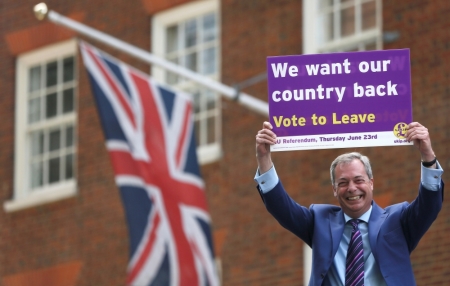 Leader of the United Kingdom Independence Party Nigel Farage holds a placard as he launches his party's EU referendum tour bus in London, Britain, May 20, 2016.