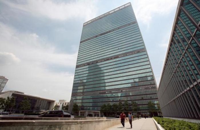 People walk in front of the United Nations Headquarters in New York July 31, 2008.