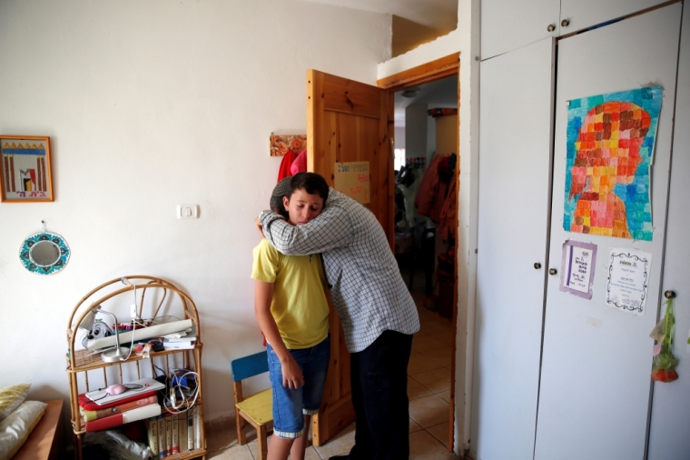 Relatives hug each other at the bedroom of Israeli girl, Hallel Yaffa Ariel, 13, who was killed in a Palestinian stabbing attack in her home in the West Bank Jewish settlement of Kiryat Arba, near the West Bank city of Hebron June 30, 2016.