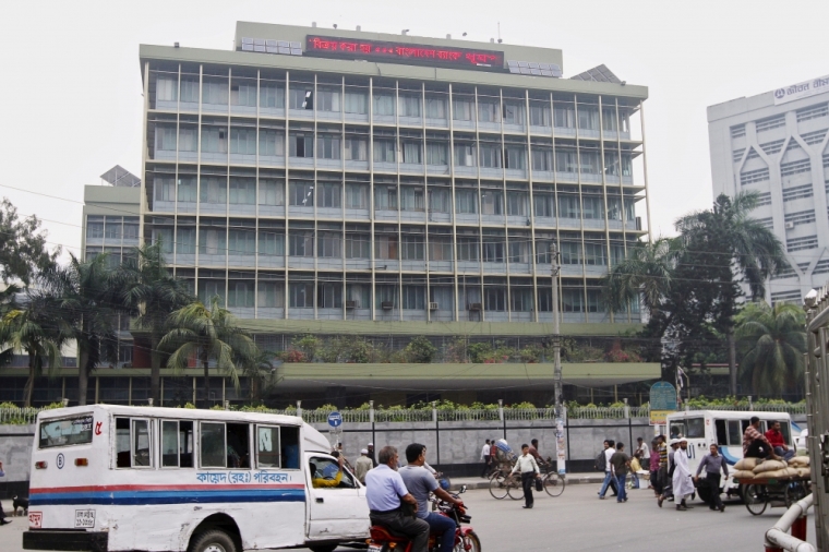 Commuters pass by the front of the Bangladesh central bank building in Dhaka, March 8, 2016.