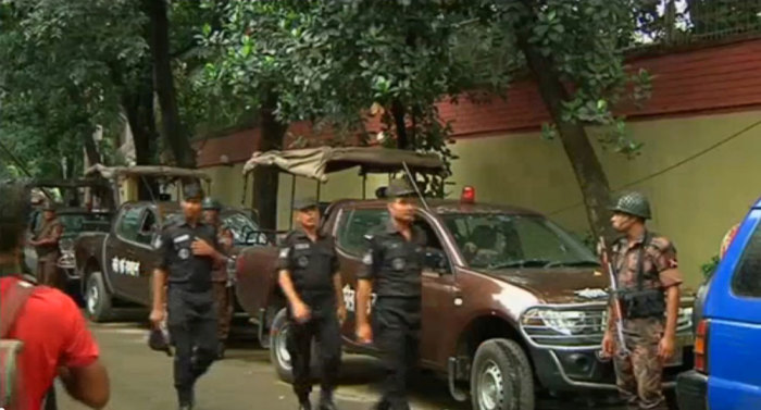 Rapid Action Battalion members walk as police stormed the Holey Artisan restaurant after gunmen attacked it and took hostages early on Saturday in Dhaka, Bangladesh in this still frame taken from live video July 2, 2016.