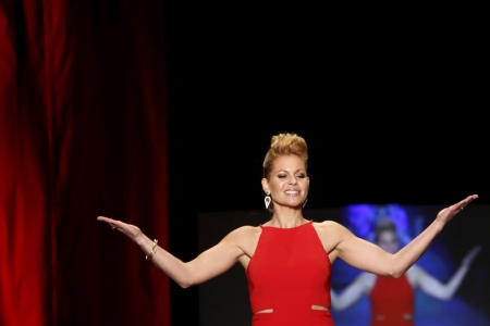 Candace Cameron-Bure presents a creation during the AHA's Go Red For Women Red Dress Collection presented by Macy's at New York Fashion Week, February 11, 2016.