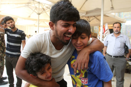 Mourners react during a funeral of a victim who was killed in a suicide car bomb in the Karrada shopping area in Baghdad, during the funeral in Najaf, south of Baghdad, Iraq, July 3, 2016.