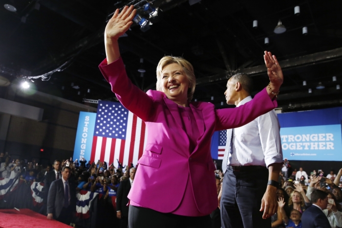 Democratic U.S. presidential candidate Hillary Clinton acknowledges supporters during a campaign rally, where she received the endorsement of U.S. President Barack Obama (R), in Charlotte, North Carolina, U.S., July 5, 2016.