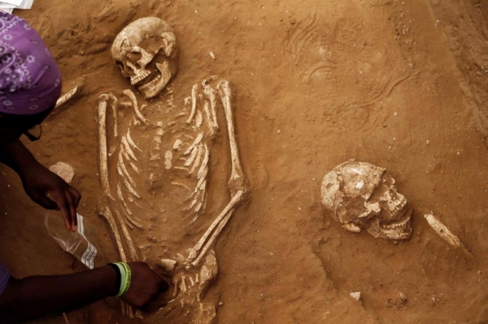 An American archaeology student unearths a skeleton during excavation works at the first-ever Philistine cemetery at Ashkelon National Park in southern Israel June 28, 2016.