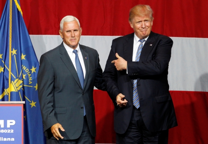 Republican presidential candidate Donald Trump (R) and Indiana Governor Mike Pence (L) wave to the crowd before addressing the crowd during a campaign stop at the Grand Park Events Center in Westfield, Indiana, July 12, 2016.