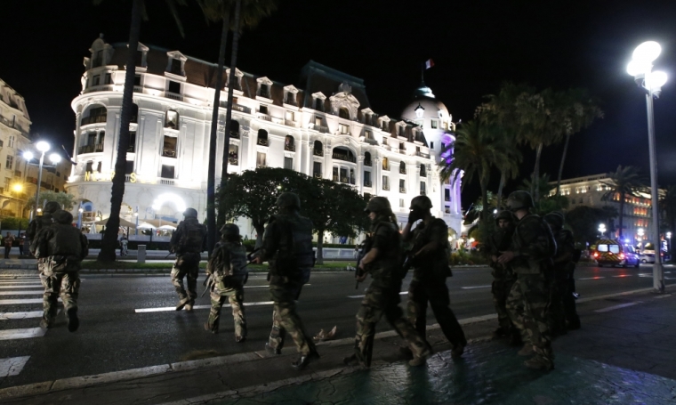 French soldiers advance on the street after at least 30 people were killed in Nice, France, when a truck ran into a crowd celebrating the Bastille Day national holiday July 14, 2016.