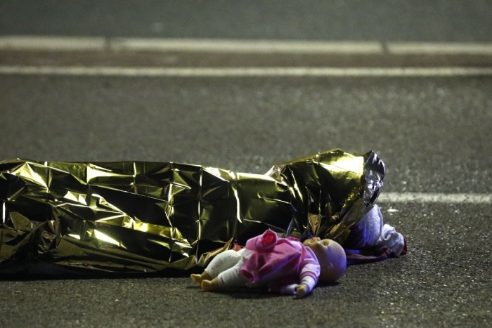 A body is seen on the ground July 15, 2016, after at least 30 people were killed in Nice, France, when a truck ran into a crowd celebrating the Bastille Day national holiday July 14.