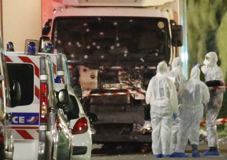 French police forces and forensic officers stand next to a truck July 15, 2016 that ran into a crowd celebrating the Bastille Day national holiday on the Promenade des Anglais killing at least 60 people in Nice, France, July 14.