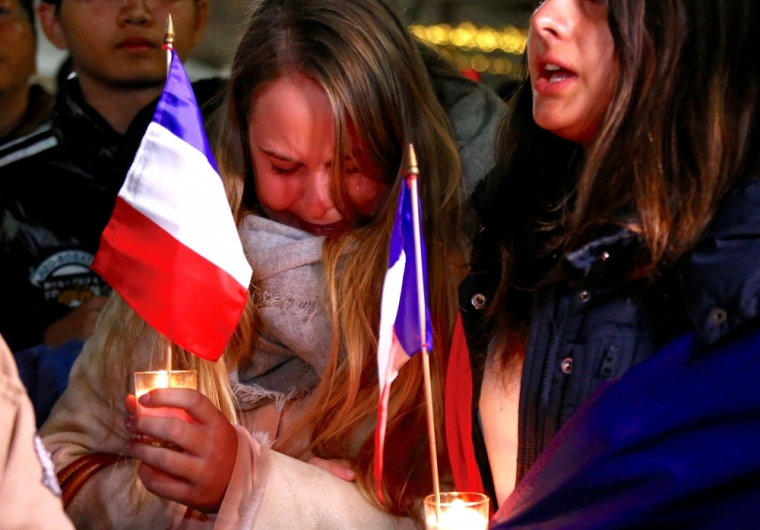 Members of the Australian French community cry as they sing the French national anthem during a vigil in central Sydney, Australia, July 15, 2016, to remember the victims of the Bastille Day truck attack in Nice.