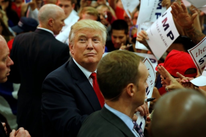 Republican presidential candidate Donald Trump signs autographs after a rally with supporters in Albuquerque, New Mexico.