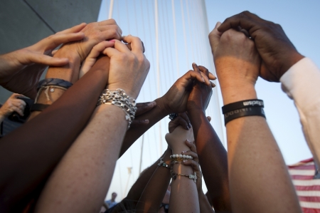 People of different races hold hands as they gather on the Arthur Ravenel Jr. bridge in Charleston, North Carolina after the first service at the Emanuel African Methodist Episcopal Church since a mass shooting left nine people dead. June 21, 2015.