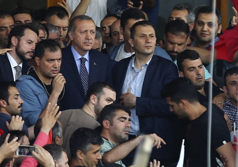 Turkish President Tayyip Erdogan is seen amid his supporters at the Ataturk Airport in Istanbul, Turkey, July 16, 2016.