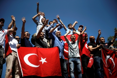 Supporters of Turkish President Tayyip Erdogan shout slogans and wave Turkish national flags during a pro-government demonstration in Sarachane park in Istanbul, Turkey, July 19, 2016.