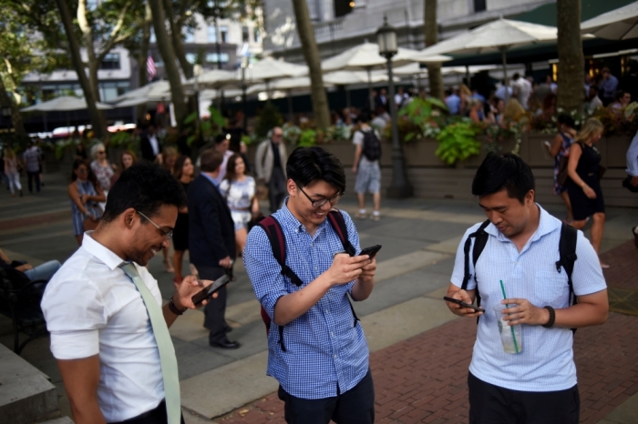 People play the augmented reality mobile game 'Pokemon Go' by Nintendo in Bryant Park, New York City, July 11, 2016.