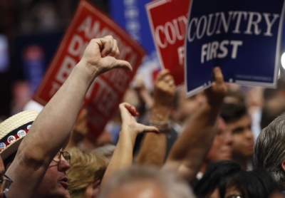 Delegates give thumbs down to the speech of former Republican U.S. presidential candidate Senator Ted Cruz as he fails to endorse Republican presidential nominee Donald Trump while speaking during the third night at the Republican National Convention in Cleveland, Ohio, U.S. July 20, 2016.