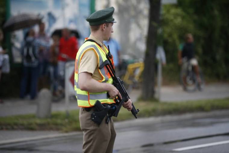 A police officer secures a road near to the scene of a shooting rampage at the Olympia shopping mall in Munich, Germany, July 22, 2016.