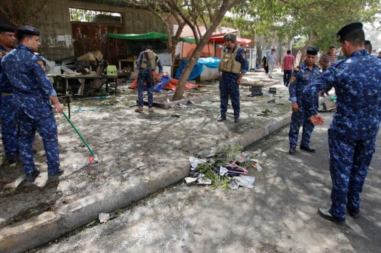 Iraqi security forces gather at the site where a suicide bomber detonated his explosive vest at the entrance to Kadhimiya, a mostly Shi'ite Muslim district in northwest Baghdad, Iraq July 24, 2016.