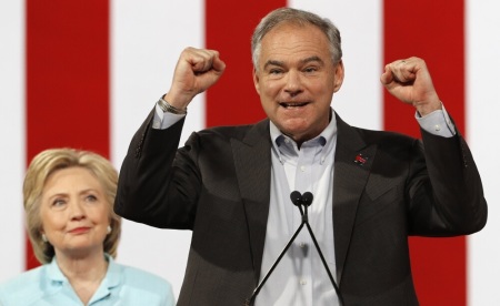 Democratic U.S. presidential candidate Hillary Clinton listens to her running-mate, Democratic U.S. vice presidential candidate Senator Tim Kaine (D-VA), after she introduced him during a campaign rally in Miami, Florida, U.S. July 23, 2016.