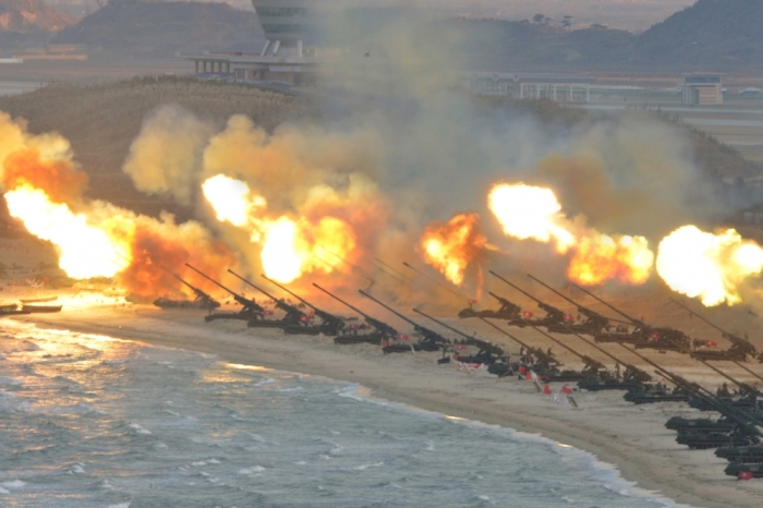 Artillery pieces are seen being fired during a military drill at an unknown location, in this undated photo released by North Korea's Korean Central News Agency (KCNA) on March 25, 2016.