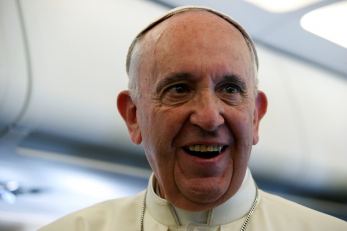 Pope Francis speaks on the plane as he travels from Italy to Poland, July 27, 2016.