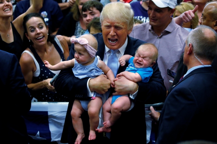 Republican presidential nominee Donald Trump holds babies at a campaign rally in Colorado Springs, Colorado, U.S., July 29, 2016.