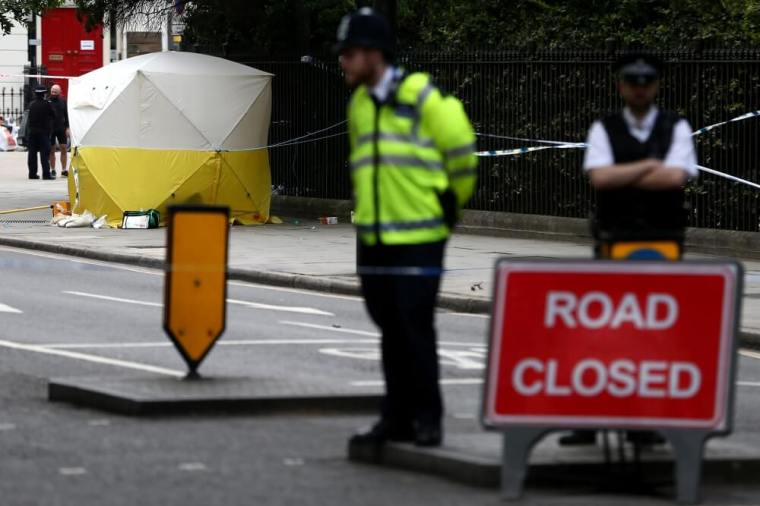 Police officers stand near a forensics tent after a knife attack in Russell Square in London, Britain, August 4, 2016