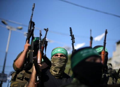 Hamas militants hold weapons as they celebrate the release of Palestinian prisoner Mohammed al-Bashiti, who served 12 years in an Israeli jail after he was convicted of being a member of Hamas' armed wing, in Rafah in the southern Gaza Strip, July 25, 2016.