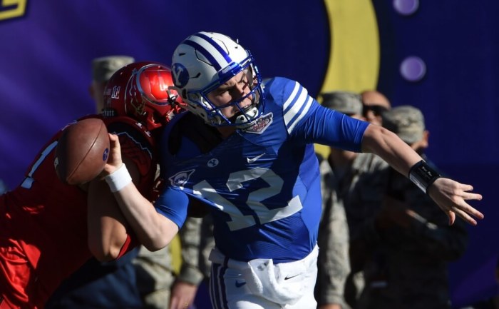 Utah Utes defensive end Kylie Fitts (11) forces a fumble by Brigham Young Cougars quarterback Tanner Mangum (12) in the Las Vegas Bowl at Sam Boyd Stadium on Dec 19, 2015 in Las Vegas, Nevada.