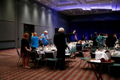 Attendees pray after Republican U.S. presidential nominee Donald Trump spoke at an American Renewal Project event at the Orlando Convention Center in Orlando, Florida, August 11, 2016.