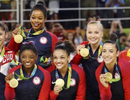 Simone Biles, Gabrielle Douglas, Laurie Hernandez, Madison Kocian, and Alexandra Raisman pose with their gold medals at 2016 Summer Olympics.