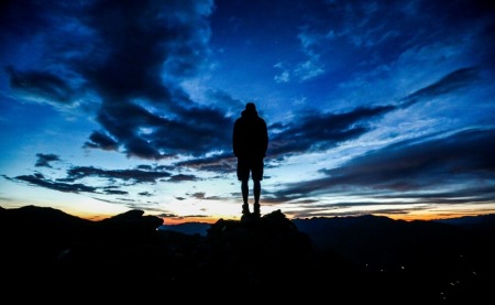 A man stands during sunrise on Kreuzjoch mountain in the Zillertal Alps in Schwendau, Austria, July 11 2016.