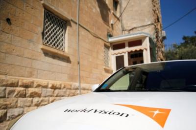 The logo of U.S.-based Christian charity World Vision is seen on a car parked outside their offices in Jerusalem, August 4, 2016.