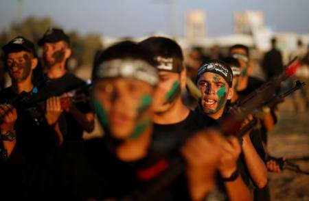 Young Palestinians take part in a military exercise graduation ceremony at a summer camp organized by Hamas's armed wing, east of Gaza City, July 22, 2016.