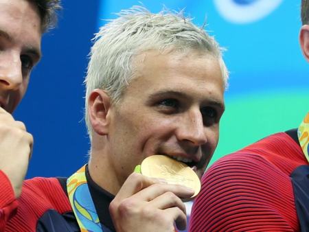 Aug 9, 2016; Rio de Janeiro, Brazil; Conor Dwyer (USA) , Townley Haas (USA) , Ryan Lochte (USA) and Michael Phelps (USA) with their gold medals after the men's 4x200m freestyle relay final in the Rio 2016 Summer Olympic Games at Olympic Aquatics Stadium. Mandatory Credit: Jason Getz-USA TODAY Sports