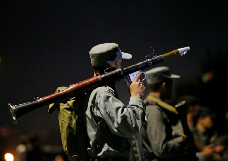 Afghan policemen stand guard at the site of an attack at American University of Afghanistan in Kabul, Afghanistan, August 24, 2016.