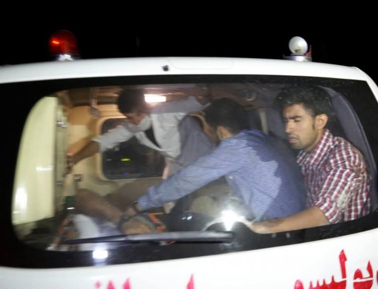 Afghan men sit in an ambulance after they were rescued from the site of an attack at American University of Afghanistan in Kabul, Afghanistan,August 24, 2016.