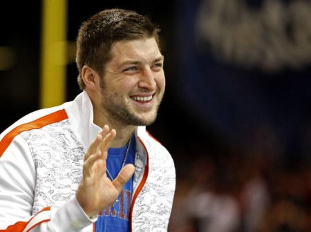 Former Florida Gators quarterback Tim Tebow waves as he stands on the sidelines before the Gators play against the Louisville Cardinals in the 2013 Allstate Sugar Bowl NCAA football game in New Orleans, Louisiana January 2, 2013. Tebow once played for the NFL's New York Jets.