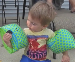 Adorable Toddler Really Wants to Eat a Cookie But His Floaties Won't Let Him! (VIDEO)