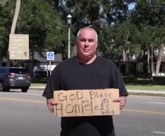 Man arrested for holding ‘God bless the homeless vets’ sign sues city